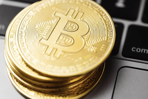 Bitcoin stacked on Apple laptop