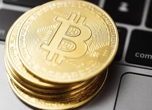 Bitcoin stacked on Apple laptop